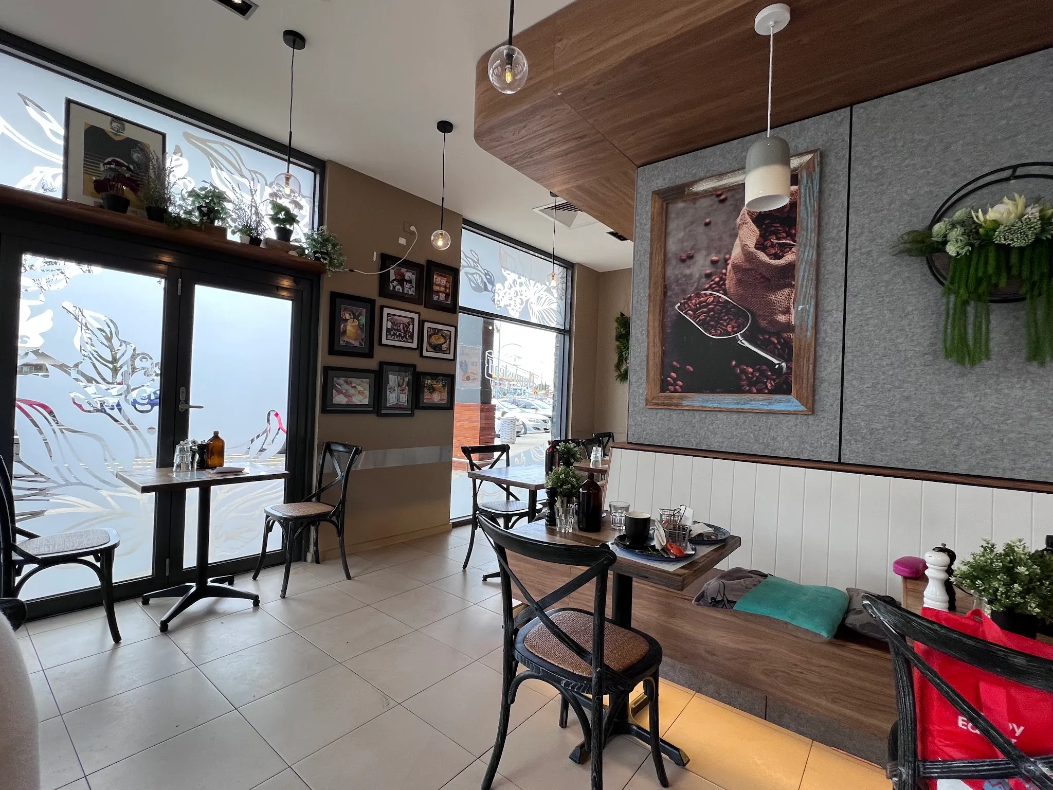 Cafe interior with bistro tables, chairs and etched glass entry doors