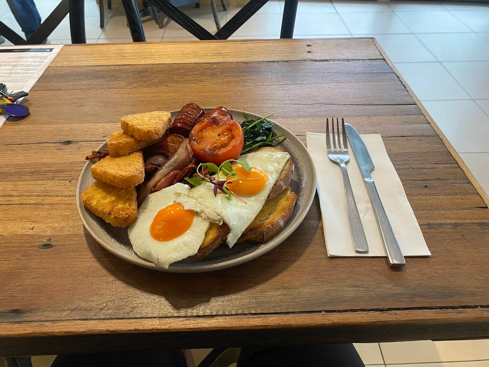 Big breakfast plate with eggs, bacon, hash browns and sausage