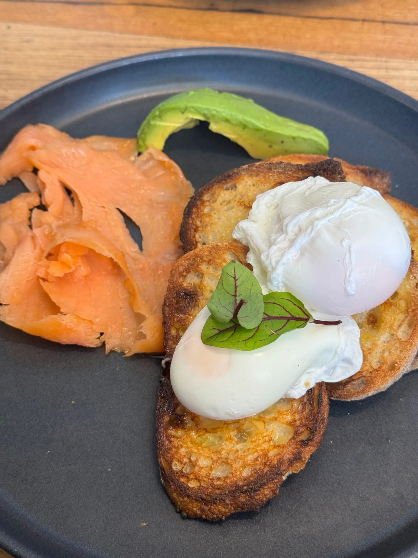 Poached eggs on toast with smoked salmon and avocado
