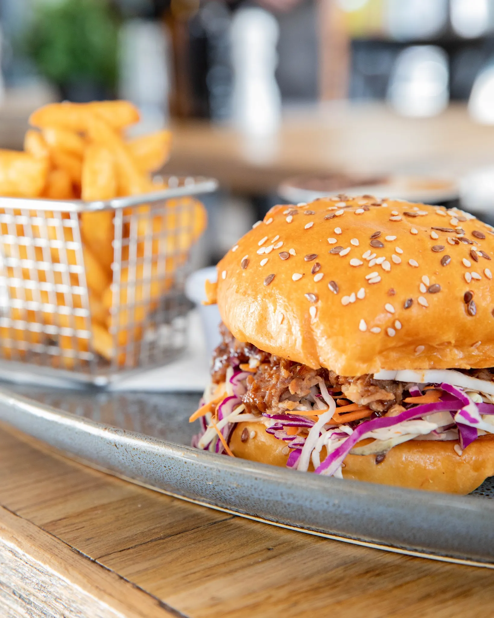 Pulled pork burger with slaw and a side of fries