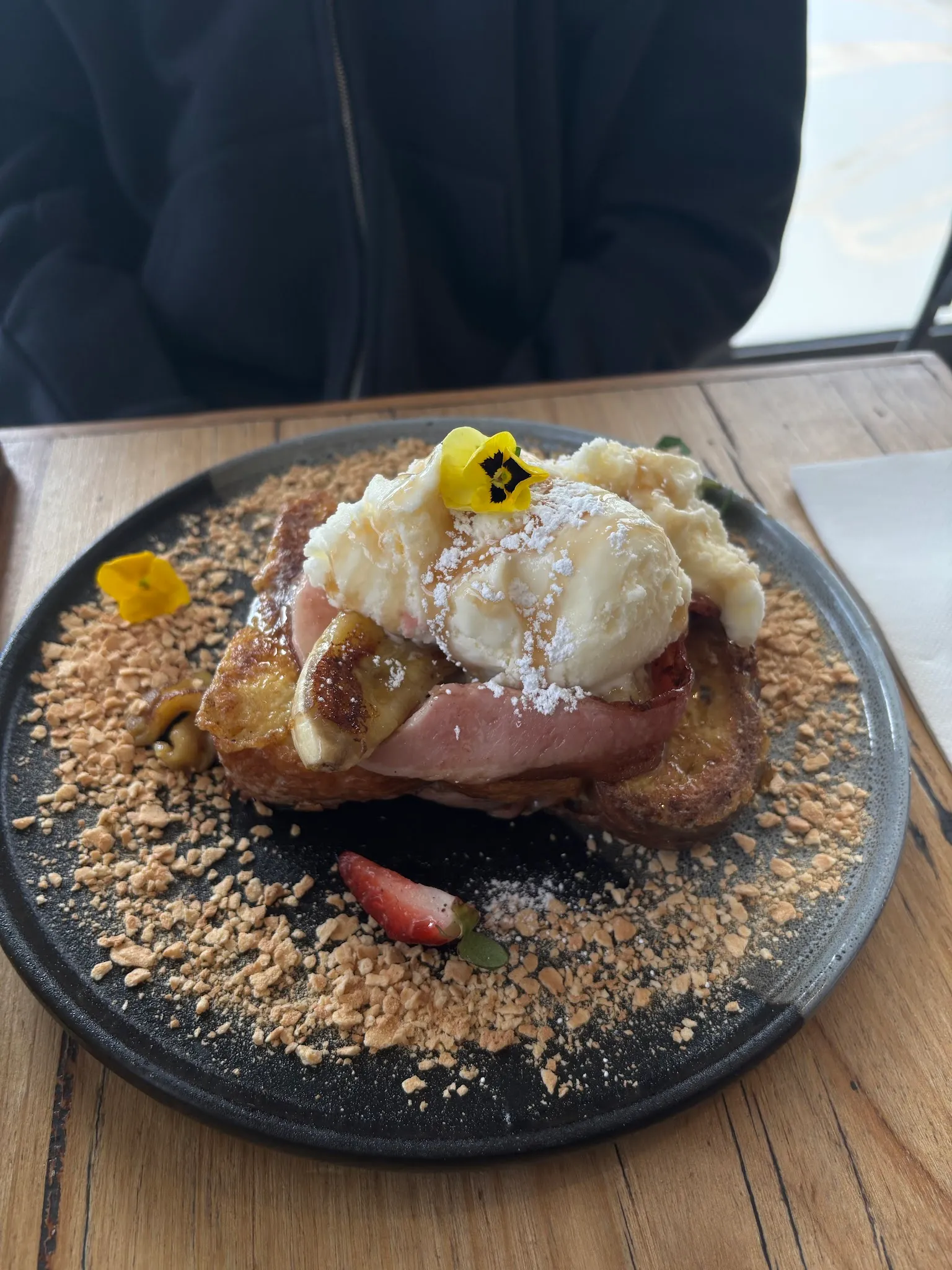 French toast with banana, bacon, ice cream and an edible flower